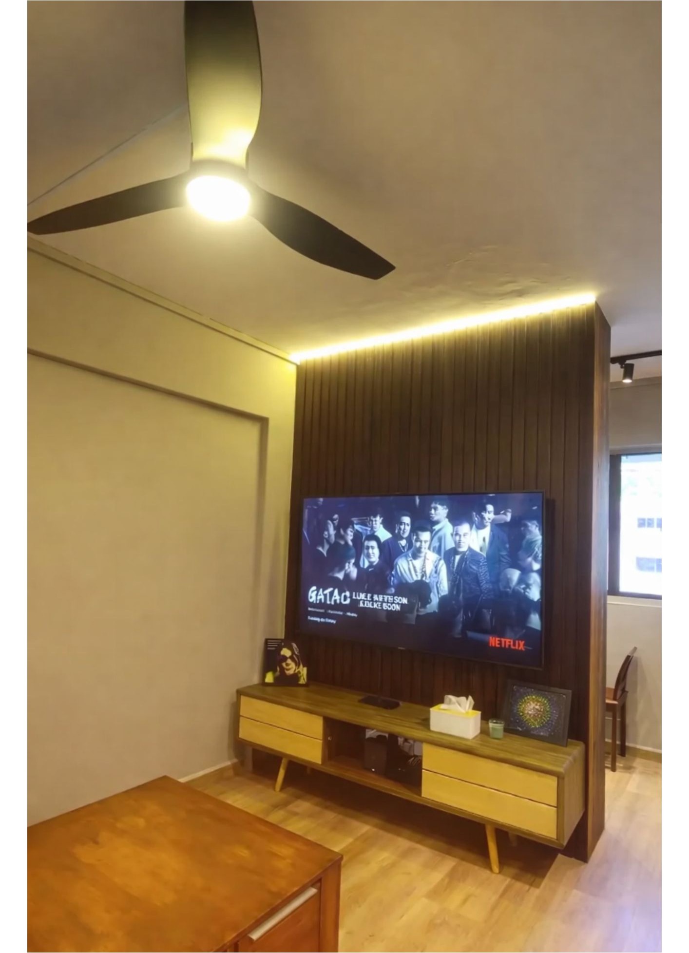 TV feature wall with dark timber slats, LED cove lighting and retro TV console