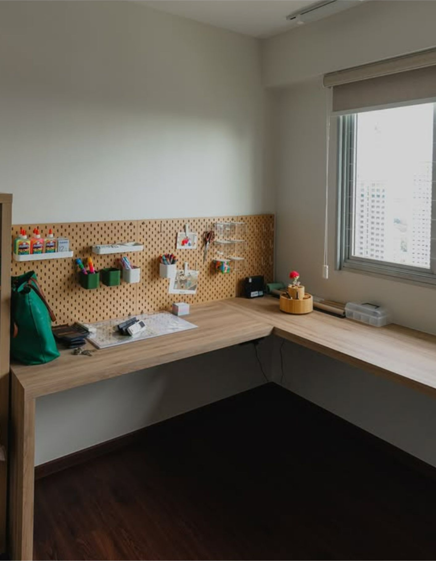 Kids study room with L-shaped timber desk and pegboard wall organiser