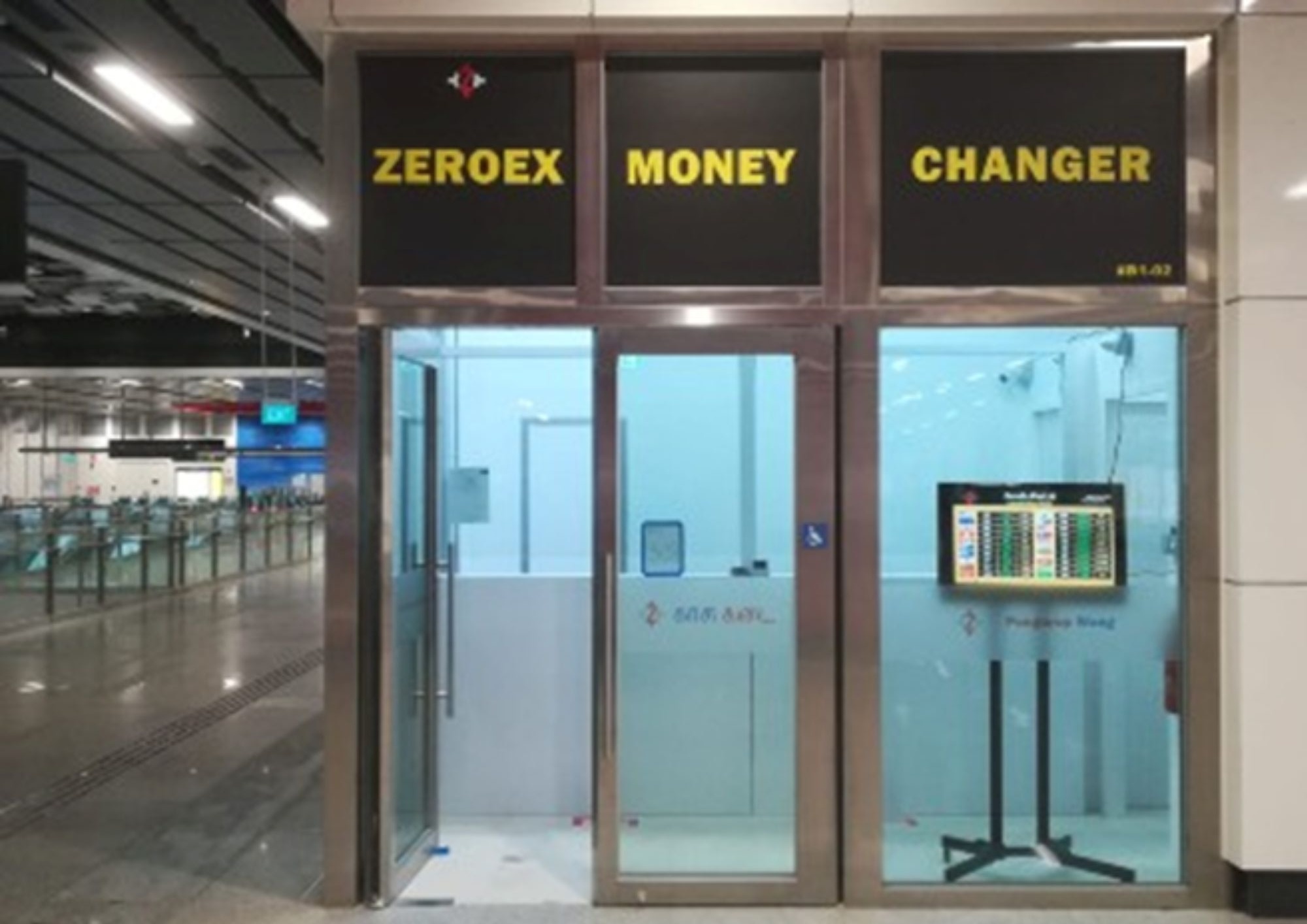 Modern minimalist retail fit-out for Zeroex Money Changer at Woodlands North MRT Singapore